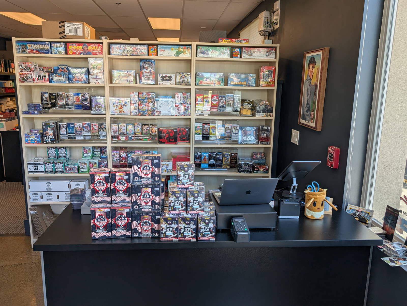 The counter and shelves of sealed product at the T206 Cards shop